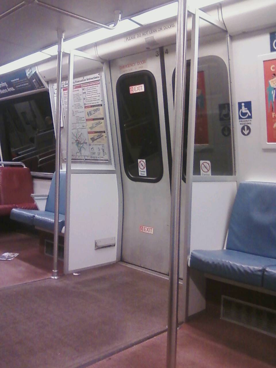 Door
partition in a WMATA/DC Metro 2000 series car. Note this partition
includes the wind screen. These partitions are full length from the floor
almost to the ceiling, which serve as adequate protection against the
elements when platforming outdoors for passengers seated near the doors. 
The dividers also serve to separate people entering/exiting the train 
from those seated so they don't brush up against seated passengers. DC
Metro's 7000-series cars offer no such protection, and passengers seated 
near the doors will likely be rained on and/or experience temperature 
swings as the train platforms outdoors. title=